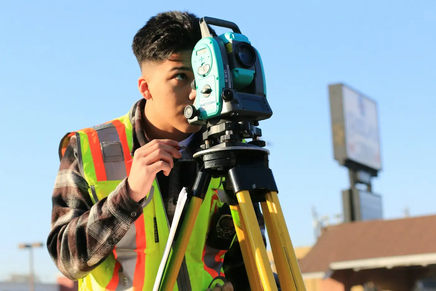 A young site engineer setting up a total station